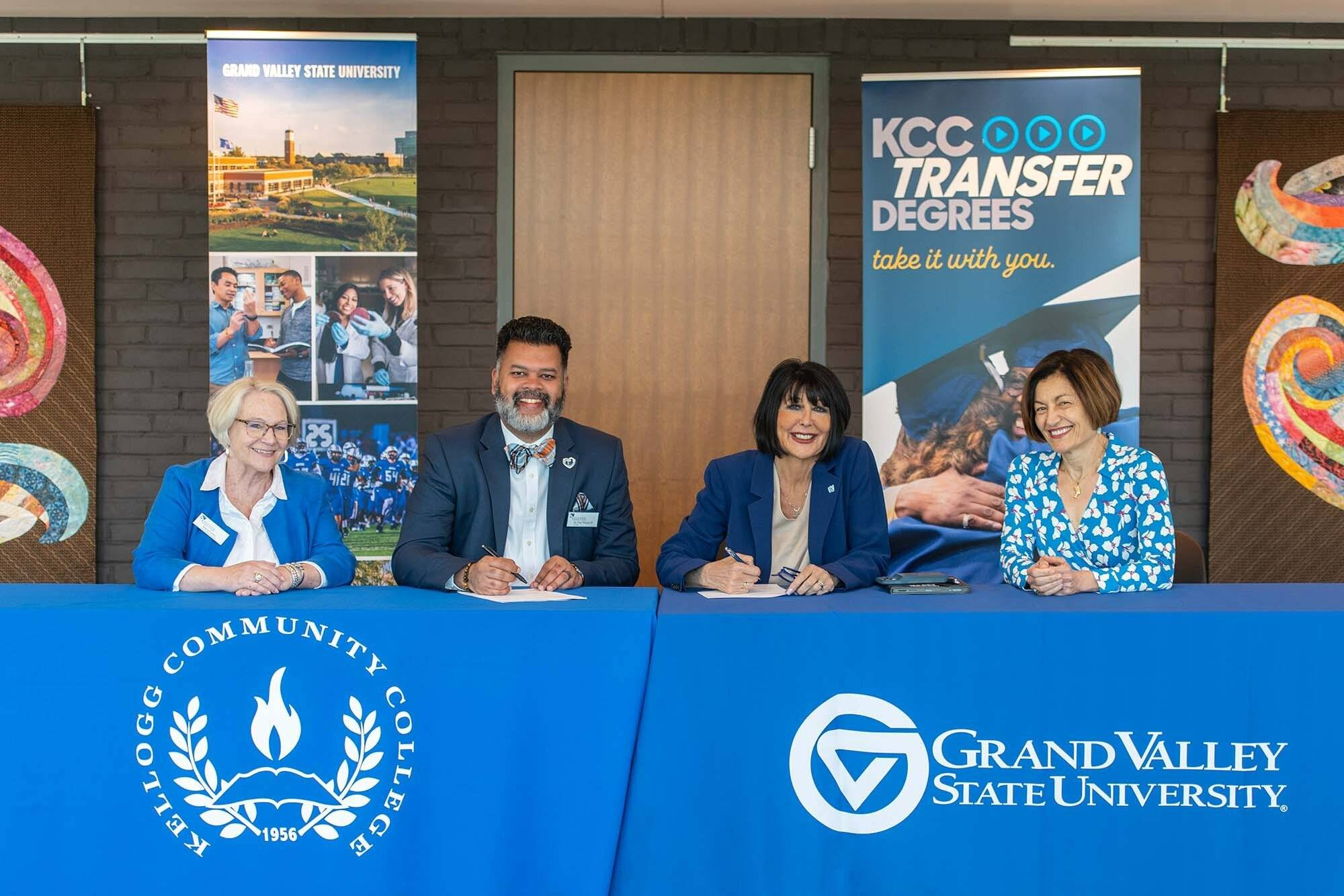 GVSU president and provost with KCC president and vice president signing papers at a table